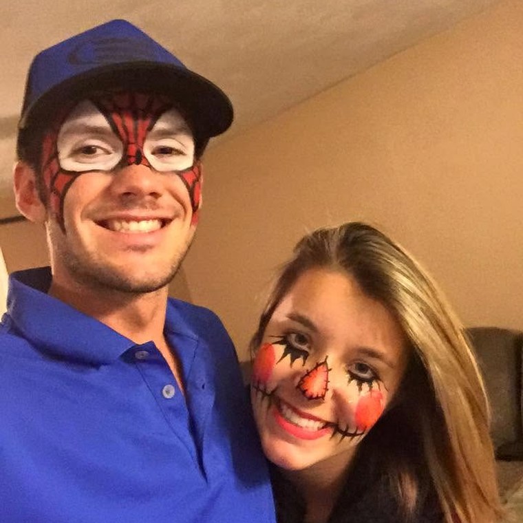 A couple in spider hero and scarecrow face paint