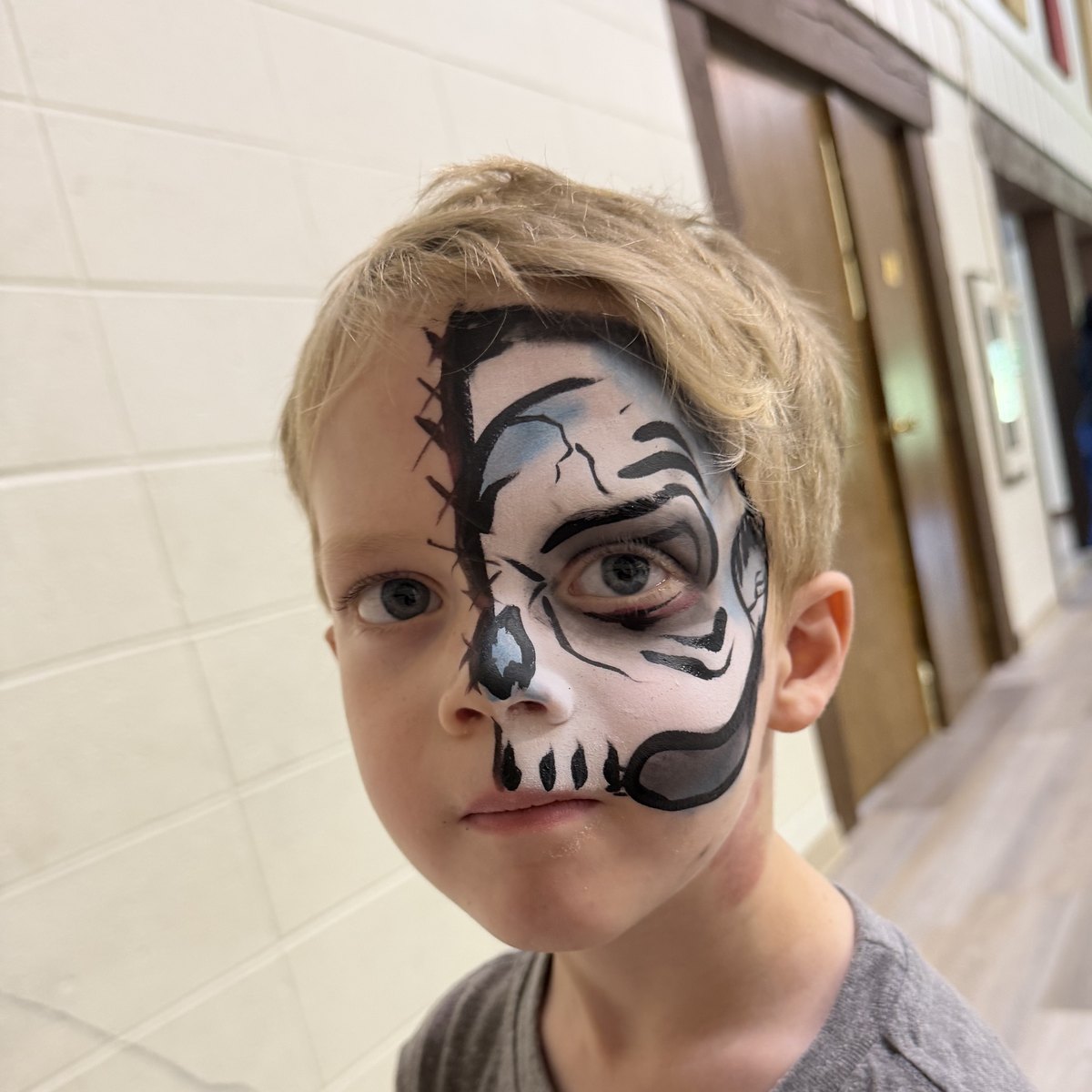 Half-face skull and stitches design on a boy